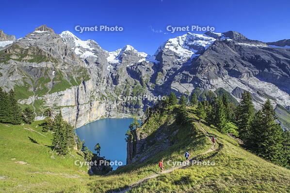 Hikers around Lake  Oeschinensee Bernese Oberland Kandersteg Canton of Bern Switzerland Europe [AWL110002180]