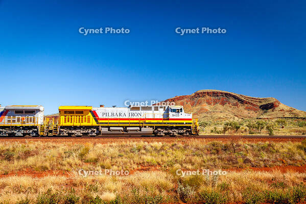 Pilbara Iron diesel locomotive carrying iron ore through outback. Pilbara Outback, Pilbara, Western Australia, Australia [AWL110002229]