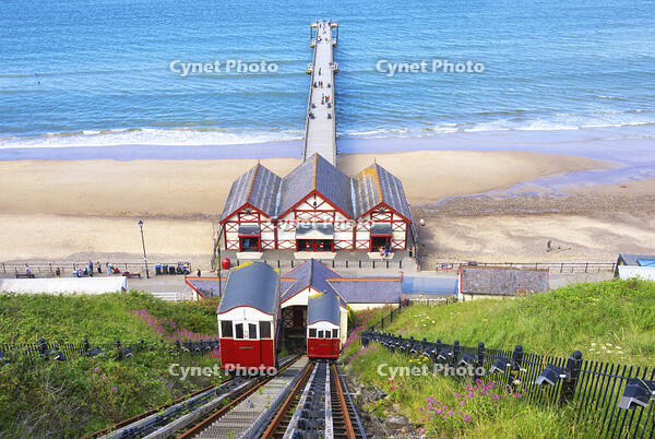 The Saltburn Cliff Tramway, Britain's oldest water balanced cliff funicular, with the pleasure pier in the background, in Saltburn-by-the-Sea, North Yorkshire, England [AWL110002244]
