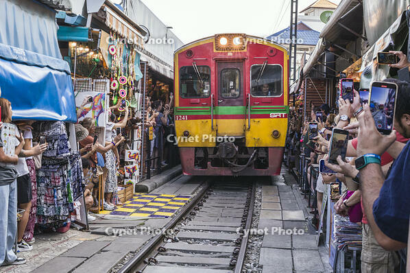 Train through the Maeklong Market with tourists, Bangkok, Thailand [AWL120000047]