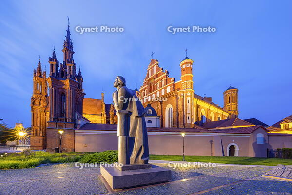 A Statue of the Polish Poet Adam Mickiewicz in front of St. Anne's Church and the Church of St. Francis and St. Bernard at Dusk, Vilnius, Lithuania [AWL110002453]