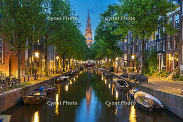 Zuiderkerk Tower near trees and buildings at Groenburgwal canal at twilight, Nieuwmarkt, Amsterdam, Netherlands [AWL110002467]