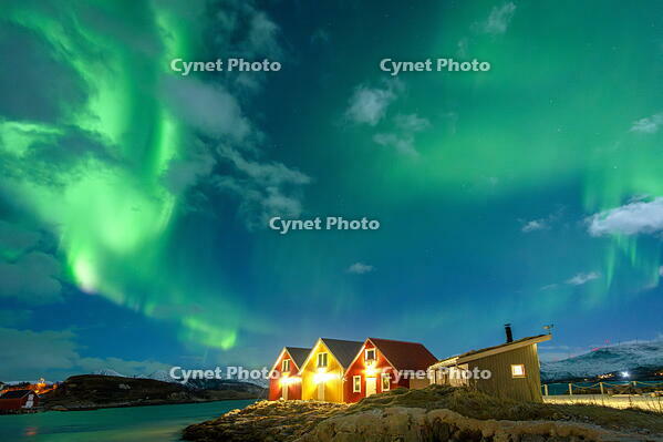Traditional rorbu hit by Northern Lights in winter, Sommaroy, Troms og Finnmark, Norway [AWL110002472]