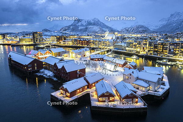 Aerial view of traditional houses covered with snow in the illuminated village of Svolvaer at night, Lofoten Islands, Norway [AWL110002473]