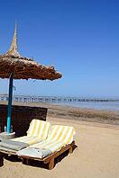 Sun beds and umbrella on the sea beach [IBR123380139]