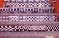 Courtyard of mediterranean villa with ceramic tile walkway and blooming bushes in Egypt [IBR123380146]