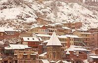 Winter view to covered with snow Tbilisi Old town in misty day [IBR123380157]