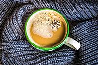 Cup of coffee with spices and christmas decorations on old wooden background with copy space [IBR123380165]