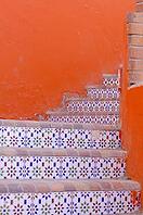 Courtyard of mediterranean villa with ceramic tile walkway and blooming bushes in Egypt [IBR123380168]
