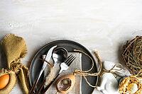 Festive table setting for easter dinner on white wooden table with copy space [IBR123380206]