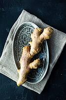 Cooking concept organic ginger root on ceramic plate [IBR123380209]