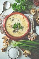 Soup with mushrooms and cream sour on rustic background with copy space [IBR123380220]