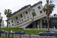 A leaning building with a restaurant in an urban environment, surrounded by palm trees and parked cars, Senate Restaurant and Lounge, Batumi, Black Sea, Adjara region, Adjara, Autonomous Republic of, Georgia [IBR112672575]
