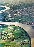 Captioned as 'aerial photo Saigon', meandering river in flat agricultural landscape of paddy fields, Vietnam, south east Asia c 1964 [IBR112672603]