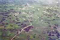 Captioned as 'aerial photo Saigon', meandering river in flat agricultural landscape of paddy fields, Vietnam, south east Asia c 1964 [IBR112672604]