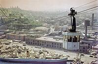 Cable car over port docks and city centre of Barcelona, Spain, Europe 1965 [IBR112672623]