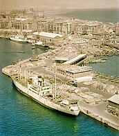 View from cable car of cargo ship 'Fylgia' in port, view to Barceloneta area, city of Barcelona, Spain Europe 1965 [IBR112672627]