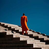Dark-skinned man in orange coat standing on stairs with back, copy space, AI generated [IBR123435169]