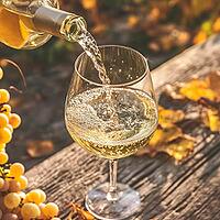White grape wine pours from a bottle into a wine glass, on a wooden table, AI generated [IBR123435187]
