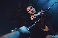 Young asian woman with chain sexy bdsm style portrait. Male hand holding chain [IBR123569347]