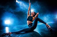 Young sexy woman pole dancing on dark background with smoke [IBR123569351]