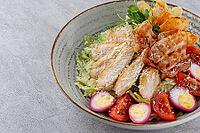 Food, Caesar salad with chicken and croutons on a gray background on a plate, photo for restaurant menu [IBR123622461]