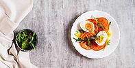 Tomato slices, egg, cheese and herbs on a plate on the table top view web banner [IBR123629691]