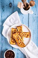 Golden sweet croutons of bread on a plate on the table top and vertical view [IBR123629708]