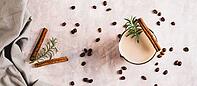 Cup of iced latte with rosemary and cinnamon on the table top view web banner [IBR123629710]