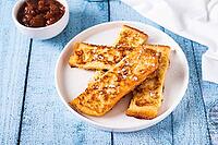 Golden sweet croutons of bread on a plate on the table [IBR123629717]