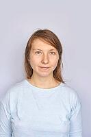 Young caucasian female in light blue shirt against plain background [IBR123629763]