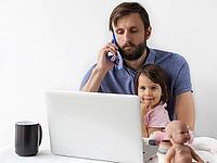 Father working remotely on laptop while talking on phone and spending time with his little daughter at home, multitasking parent lifestyle, family and work balance, fatherhood [IBR123638369]