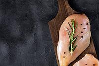 Raw fresh chicken fillet with rosemary and spices on a dark background. Food background, cooking ingredients. Top view with copy space [IBR123639510]