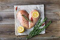 Raw chicken fillet in the shape of a heart with rosemary and spices on natural wooden background. Top view [IBR123639511]