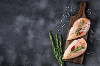 Raw fresh chicken fillet with rosemary and spices on a dark background. Food background, cooking ingredients. Top view with copy space [IBR123639520]
