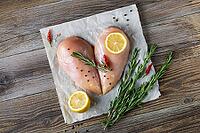Raw chicken fillet in the shape of a heart with rosemary and spices on natural wooden background. Top view [IBR123639528]
