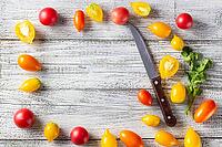 Various colorful ripe tomato on white wooden background. Cooking from yellow orange and red cherry tomatoes. Top view with copyspace [IBR123639569]