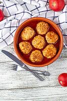 Meatballs in tomato sauce in a bowl on wooden table. Tasty dinner food. Top view copy space [IBR123639575]