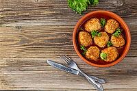 Meatballs in tomato sauce in a bowl on wooden table. Tasty dinner food. Top view copy space [IBR123639577]