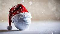 A golf ball wearing a red Santa hat, adorned with snowflakes, during snowfall at the Christmas and New Year holiday season. AI generated [IBR123641845]