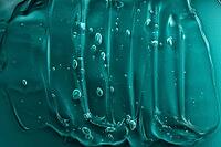 Facial skincare cleanser smudge. Abstract cosmetic texture background. Tidewater green trendy texture. Moisturizer with vitamin and aloe vera. Gel smear with bubble. Transparent beauty product. Macro [IBR123646469]