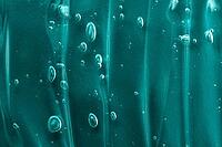 Green gel texture smear with bubble. Transparent beauty serum cosmetic product. Skincare cleanser smudge. Abstract cosmetic texture background. Tidewater green trendy texture [IBR123646489]