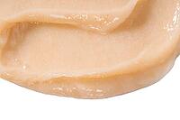 Hair conditioner cream swatch smear on white background. Yellow cosmetic lotion moisturiser sample closeup. Body care balm, retinol serum, shampoo wavy texture. Skincare mask, creamy cleanser product [IBR123646507]