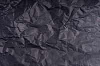 Dark wrinkled creased black paper poster texture. Blank creased crumpled grainy paper textured surface. Smudged grungy cardboard with fiber. Close up. Material tissue for packing [IBR123646512]