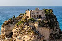 Tropea, Italy - 27.07.2023: Medieval monastery in Byzantine style, located on steep rocky cliff overlooking the sea. Sanctuary of Santa Maria dell'Isola di Tropea [IBR123646521]