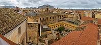 Palermo, Italy - 06.11.2022: Panoramic view of historic city rooftops and mountains under cloudy sky [IBR123646534]