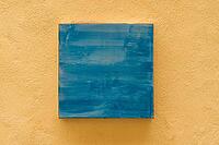 Abstract blue painting on yellow textured wall, minimalist art for modern home decor [IBR123646543]