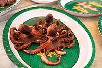 Palermo, Italy - 06.11.2022: Deliciously cooked octopus on decorative plates at festive seafood feast [IBR123646550]