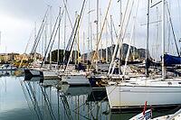 Castellammare del Golfo, Italy - 05.11.2022: Sailing boats docked in marina with mountain views for nautical adventure and travel inspiration [IBR123646553]