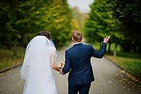 Wedding couple walking at green park [IBR123675069]